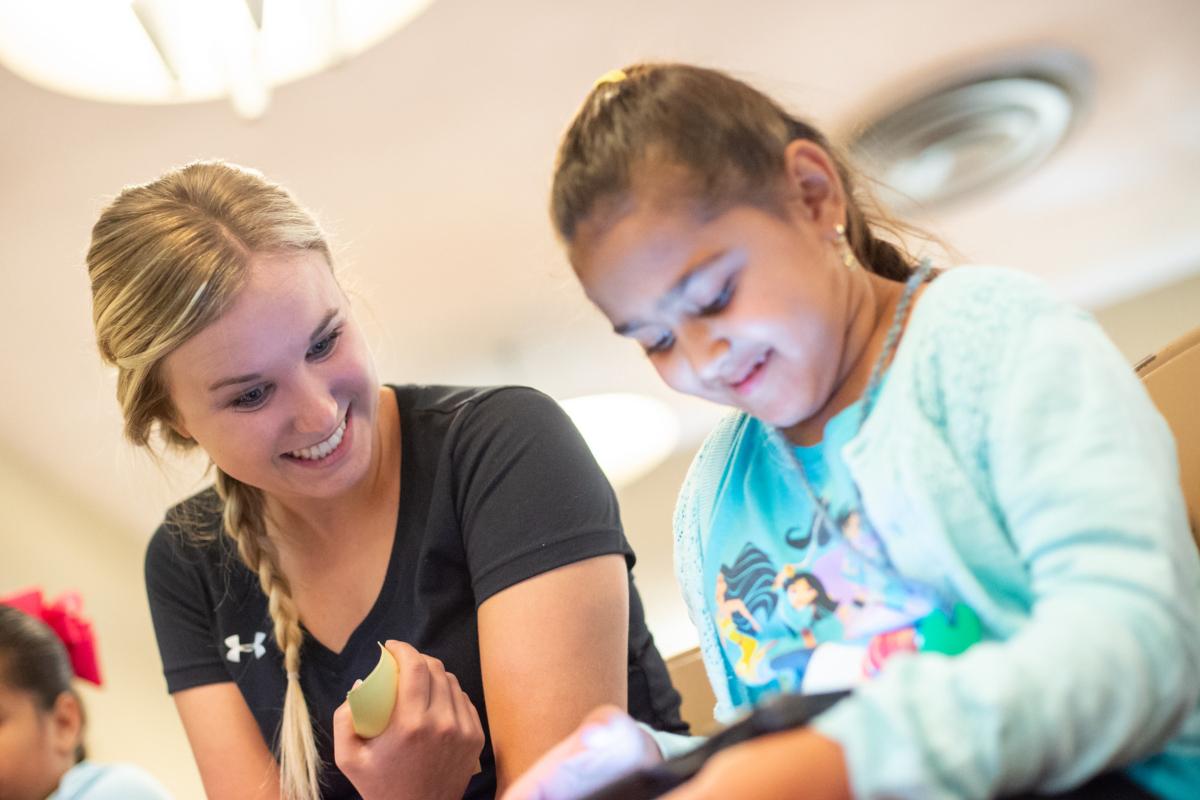 an audiology students assists a patient